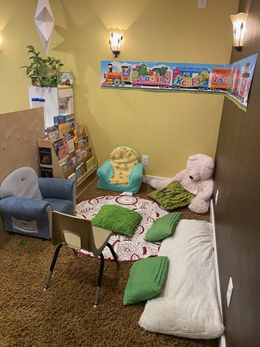 Cozy reading nook with teddy bear and cushions