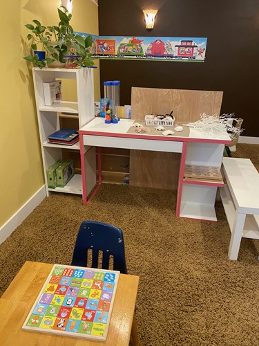 Craft and puzzle table with shelving of books and supplies