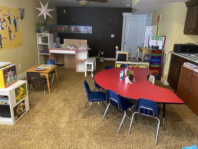 Group activity table with craft desk and decorated wall